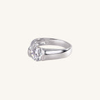 Silver ring with a diamond on a light beige background