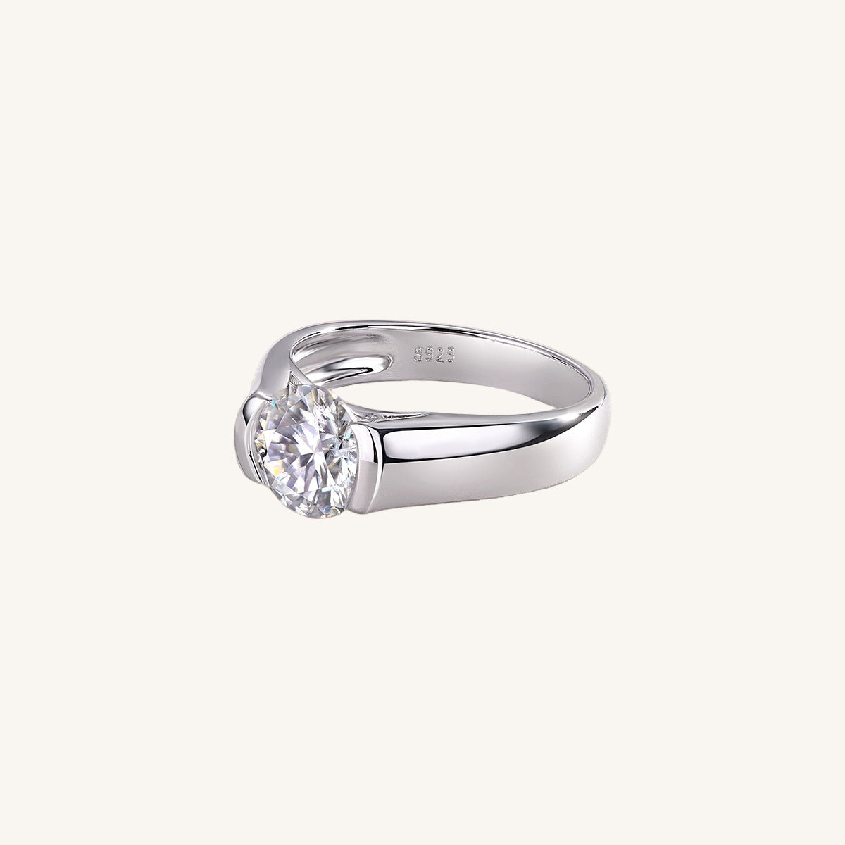 Silver ring with a diamond on a light beige background