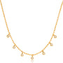 Gold necklace with small round pendants on a white background