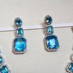 Blue gemstone earrings on a white background