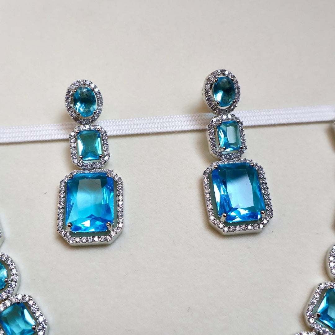 Blue gemstone earrings on a white background