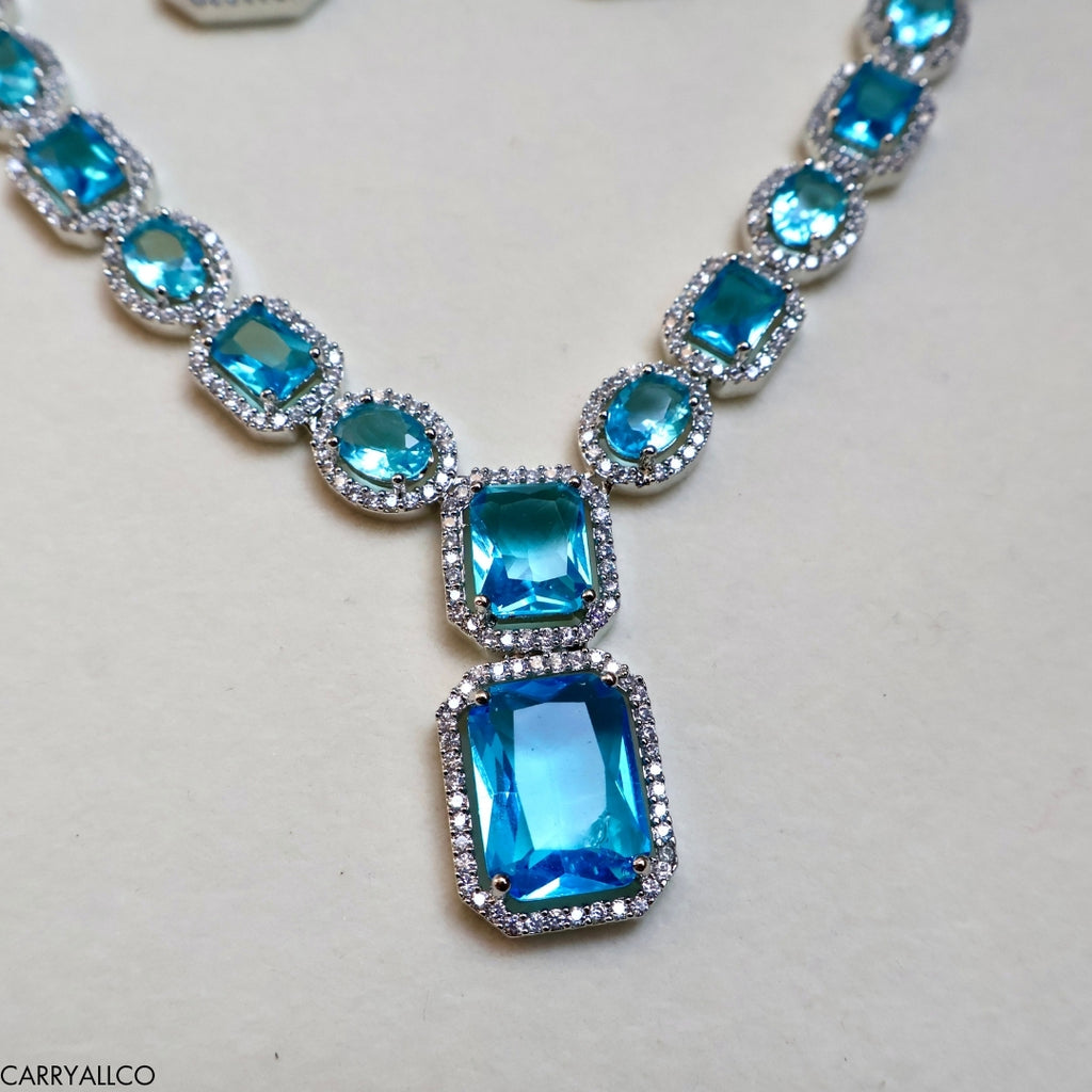 Necklace with blue gemstones on a light gray background