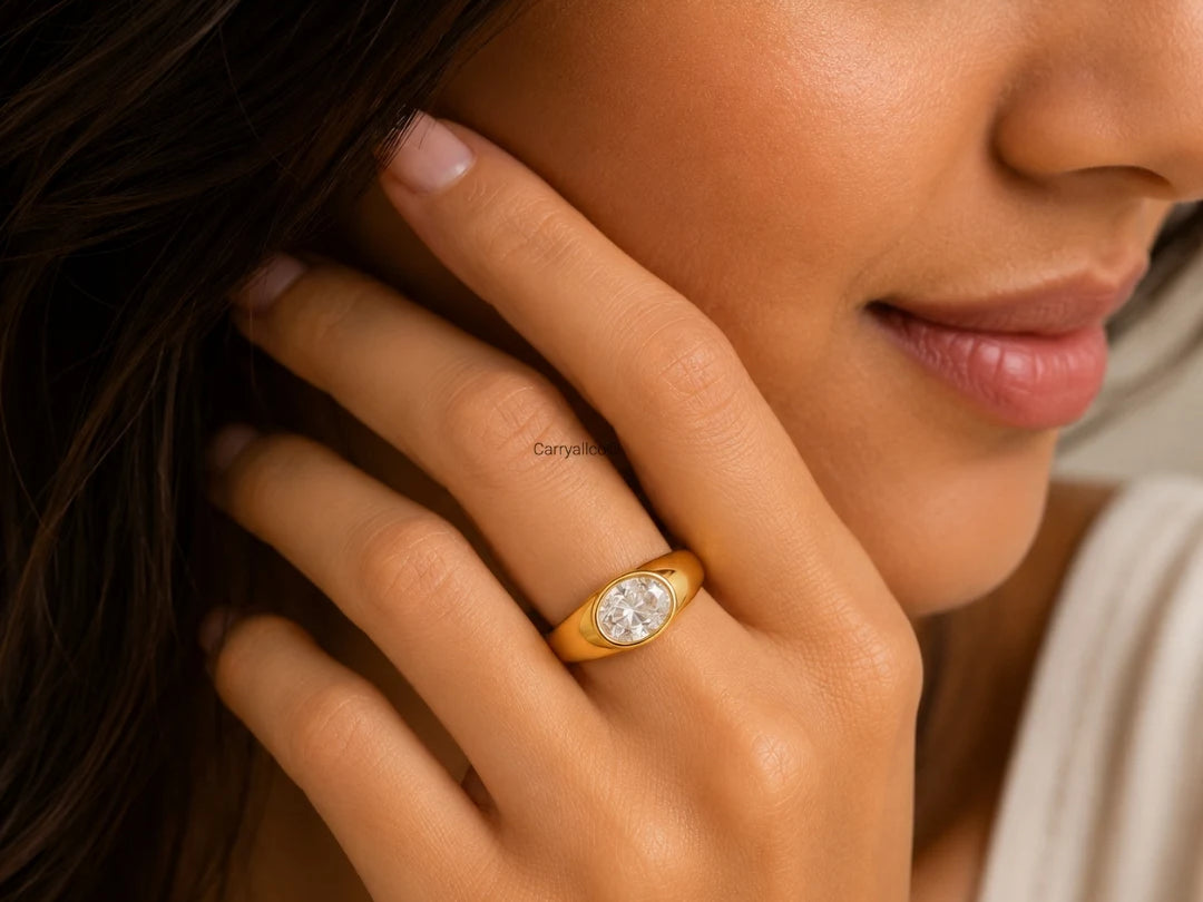 Close-up of a woman wearing a gold ring with a diamond on her hand.
