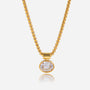 Gold necklace with a round pendant on a white background