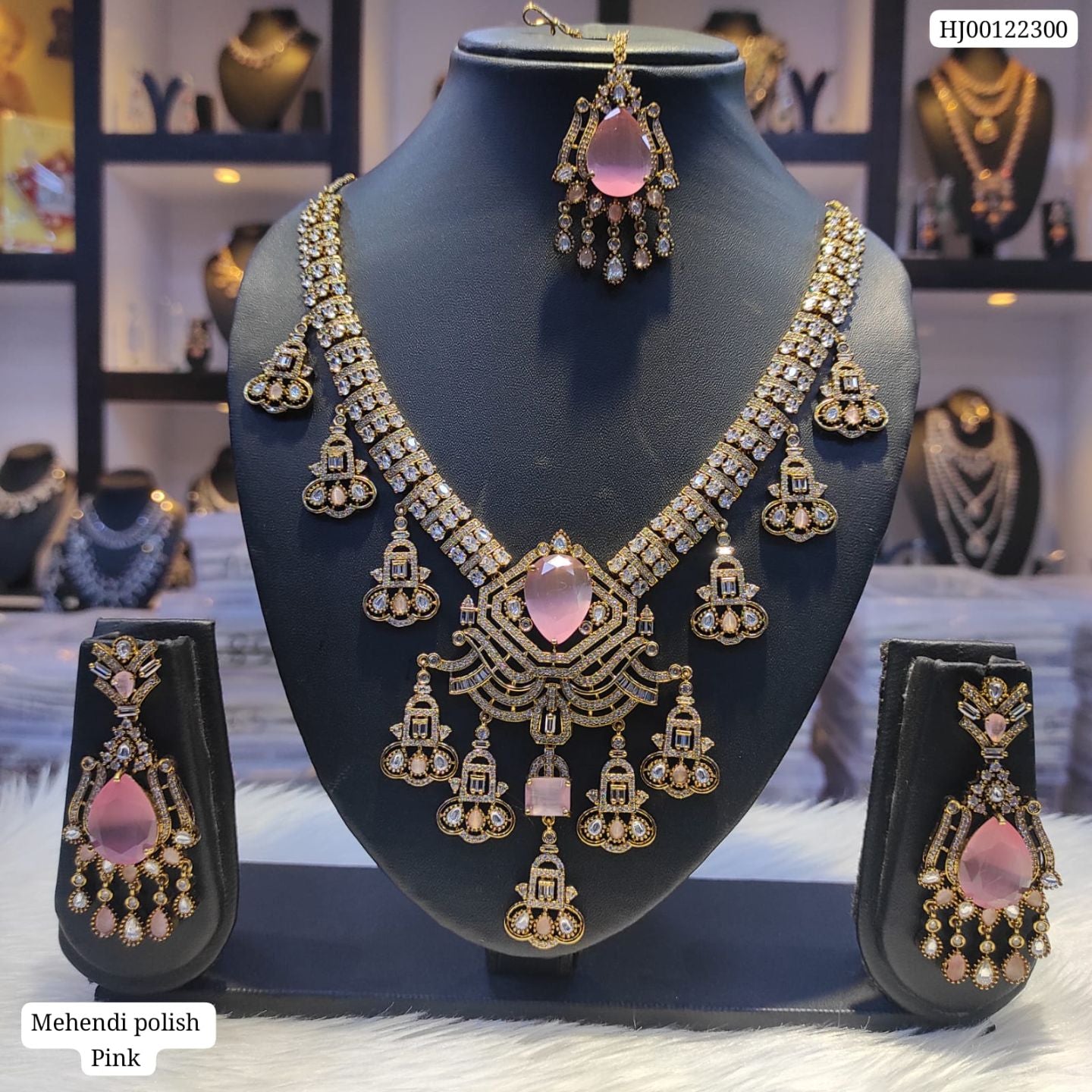 Jewelry set with necklace and earrings on a mannequin bust, with a blurred jewelry store background.
