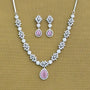 Jewelry set with necklace and earrings featuring pink stones on a brown background