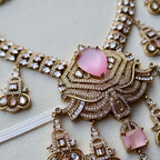 Ornate necklace with pink gemstones on a light background