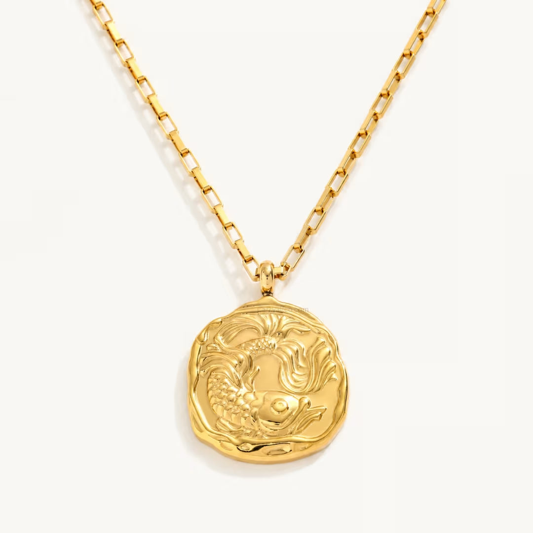 Gold necklace with a detailed pendant on a white background