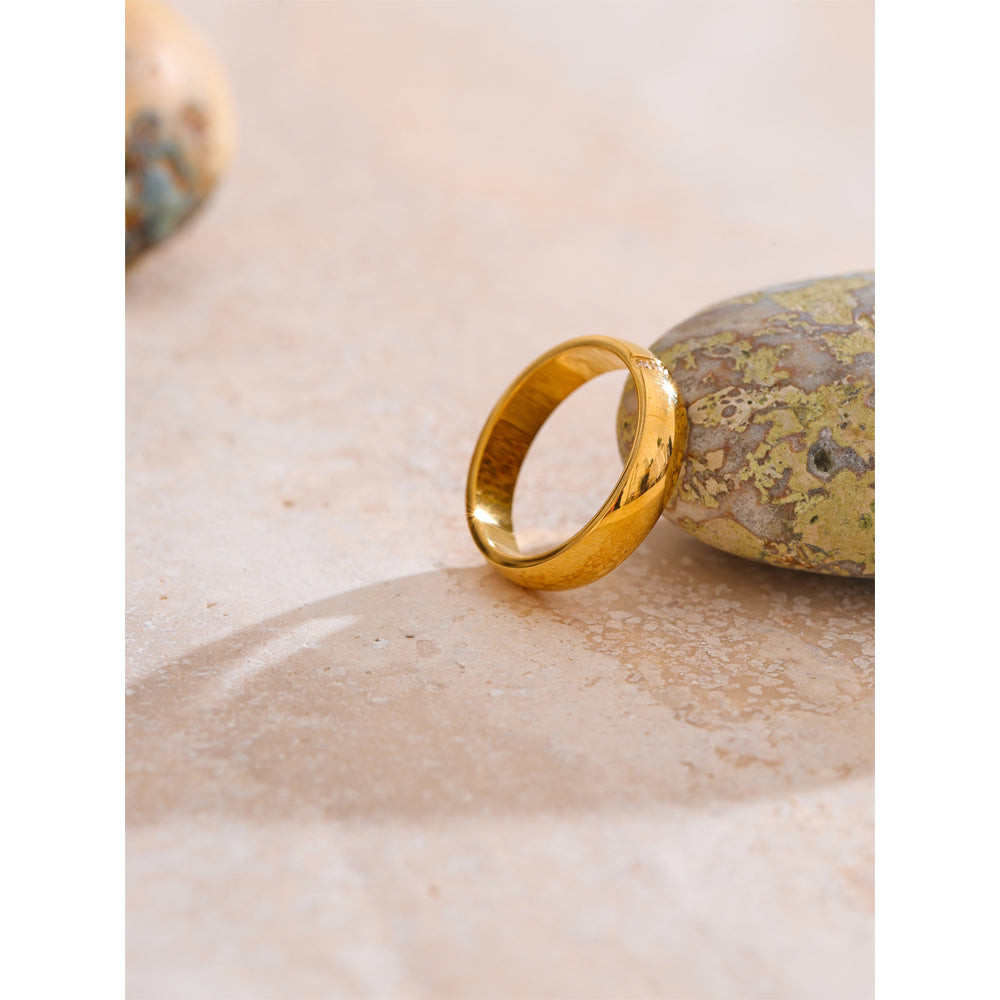 Gold ring on a textured stone surface