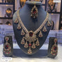 Jewelry set with necklace and earrings on a mannequin bust in a store setting.