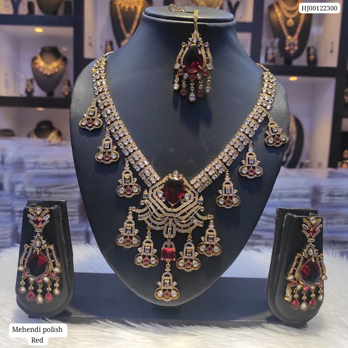 Jewelry set with necklace and earrings on a mannequin bust in a store setting.