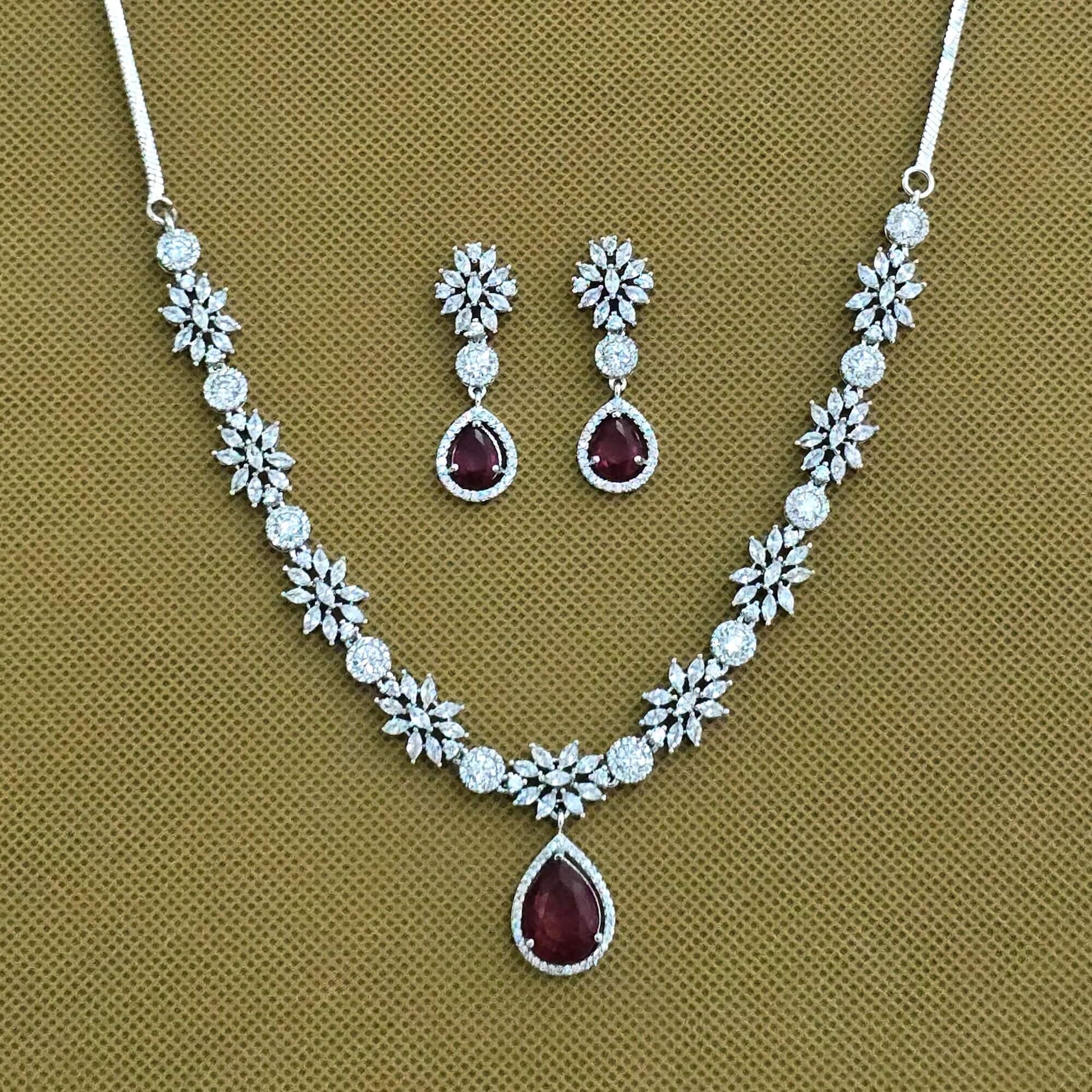 Jewelry set with necklace and earrings on a brown background