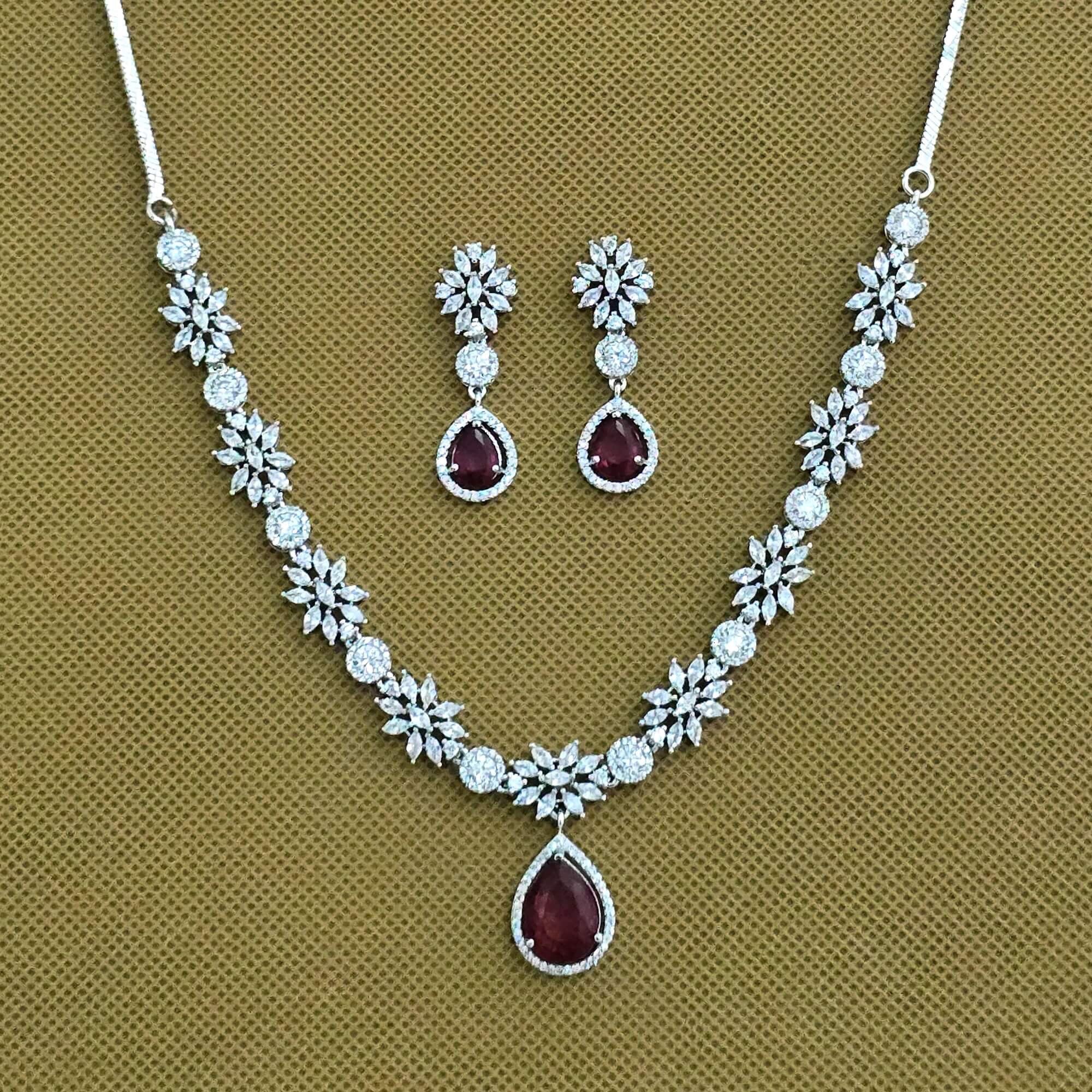 Jewelry set with necklace and earrings on a brown background
