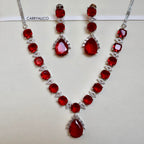 Jewelry set with red gemstones and silver accents on a white background