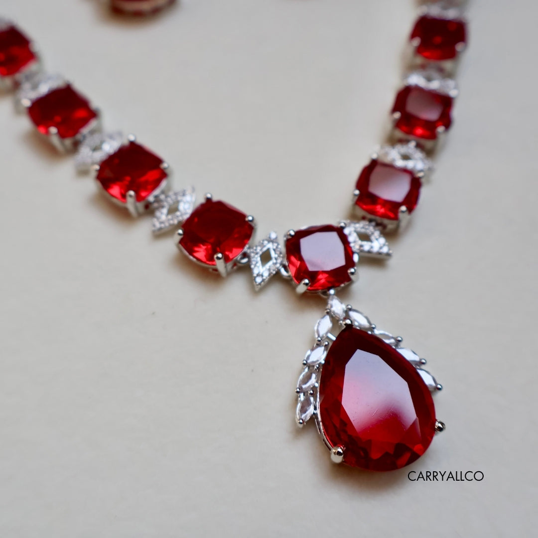 Necklace with red gemstones and silver accents on a light background
