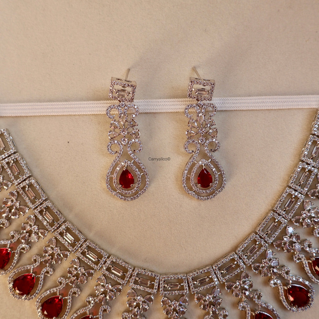 Jewelry set with necklace and earrings on a beige background
