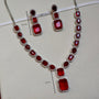 Red gemstone necklace and earrings with measurements on a white background