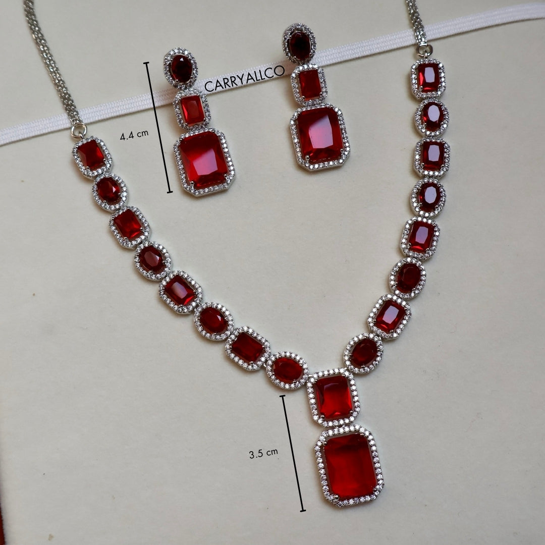Red gemstone necklace and earrings with measurements on a white background