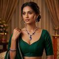 Woman wearing a green saree with jewelry in an elegant indoor setting