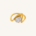Gold ring with a clear gemstone on a white background