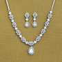 Jewelry set with necklace and earrings on a beige background