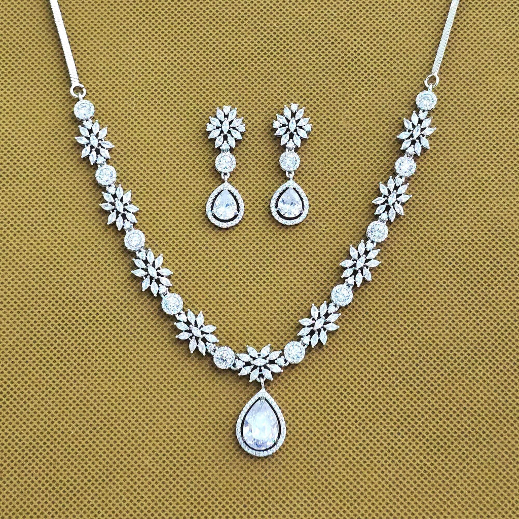 Jewelry set with necklace and earrings on a beige background