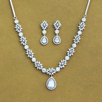 Jewelry set with necklace and earrings on a beige background