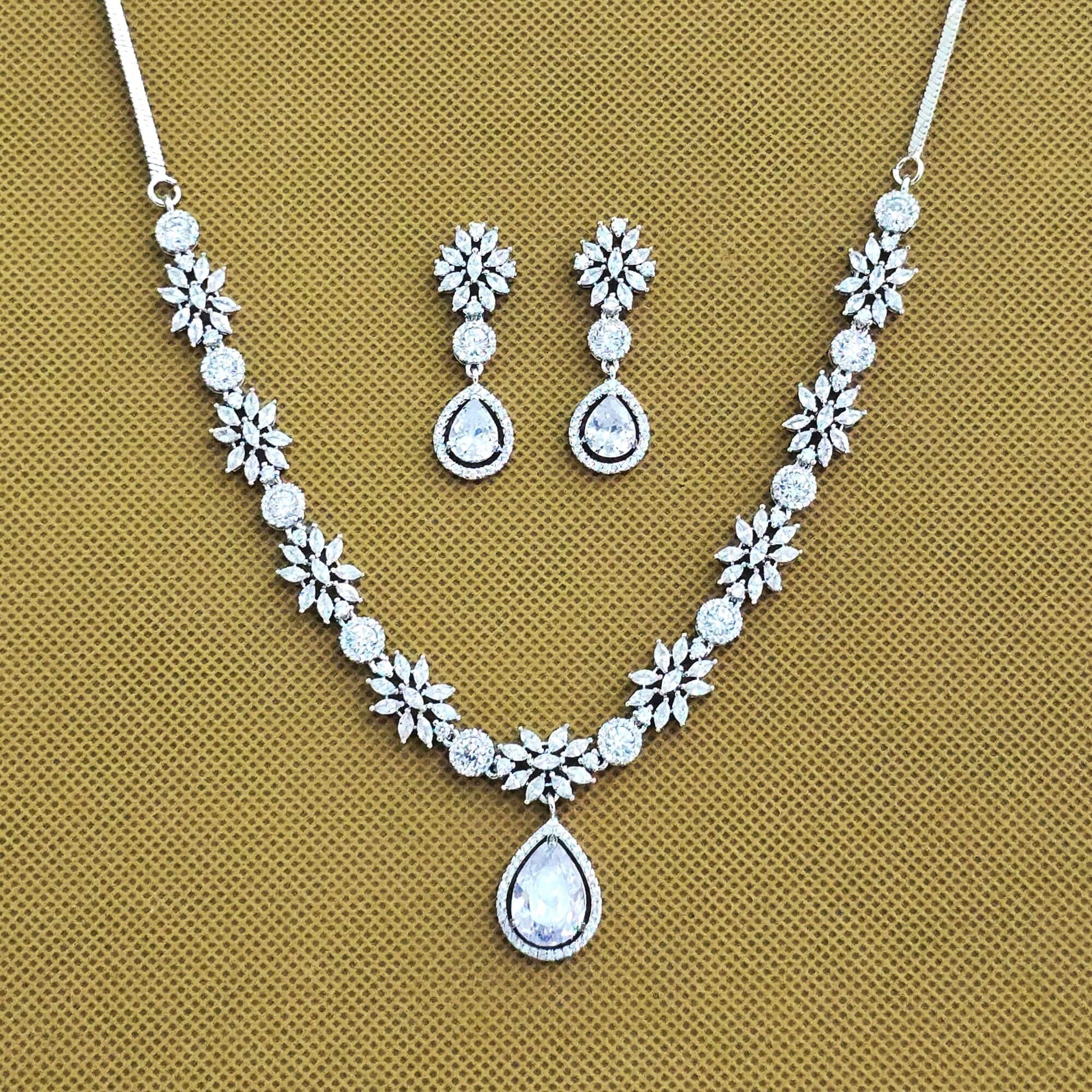 Jewelry set with necklace and earrings on a beige background