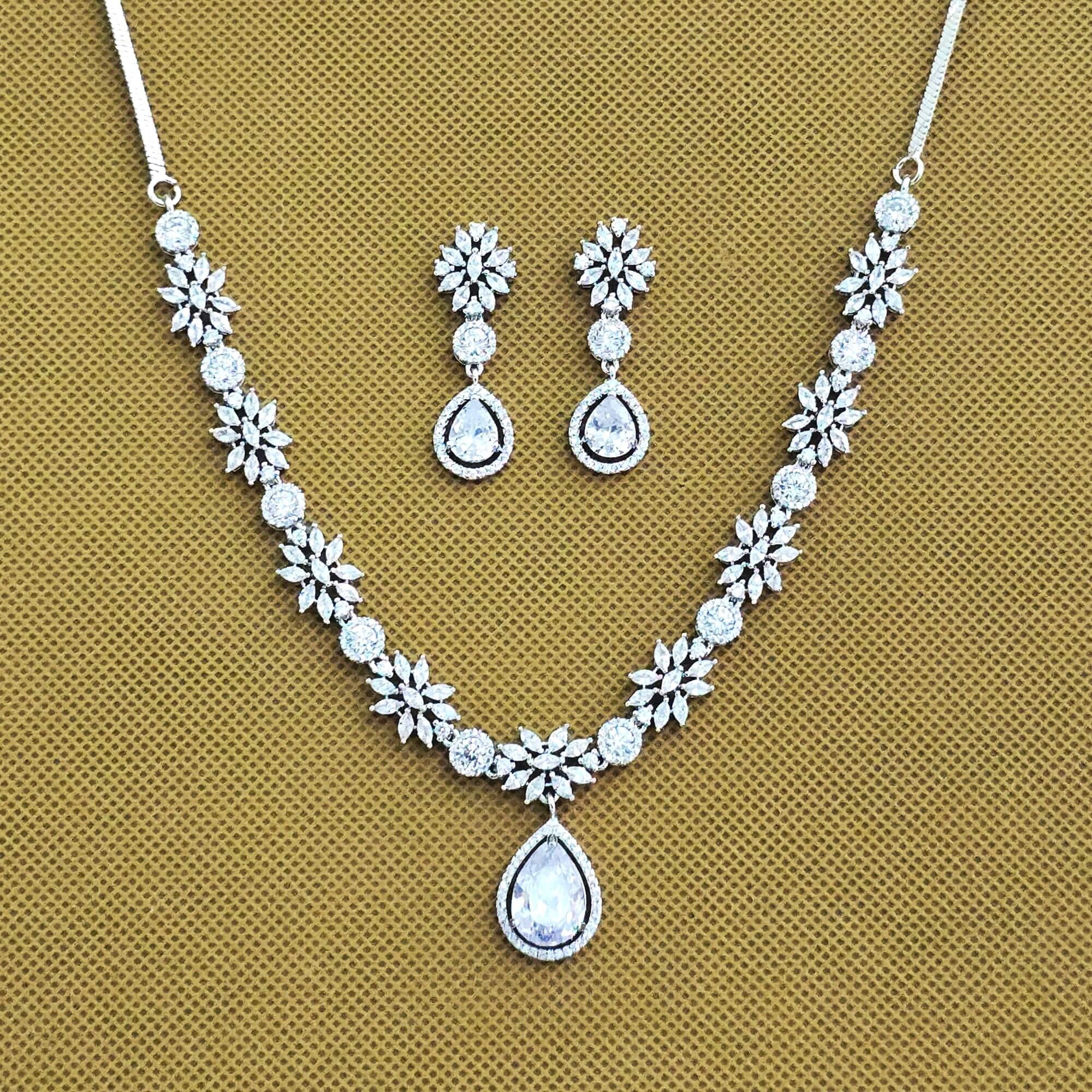 Jewelry set with necklace and earrings on a beige background