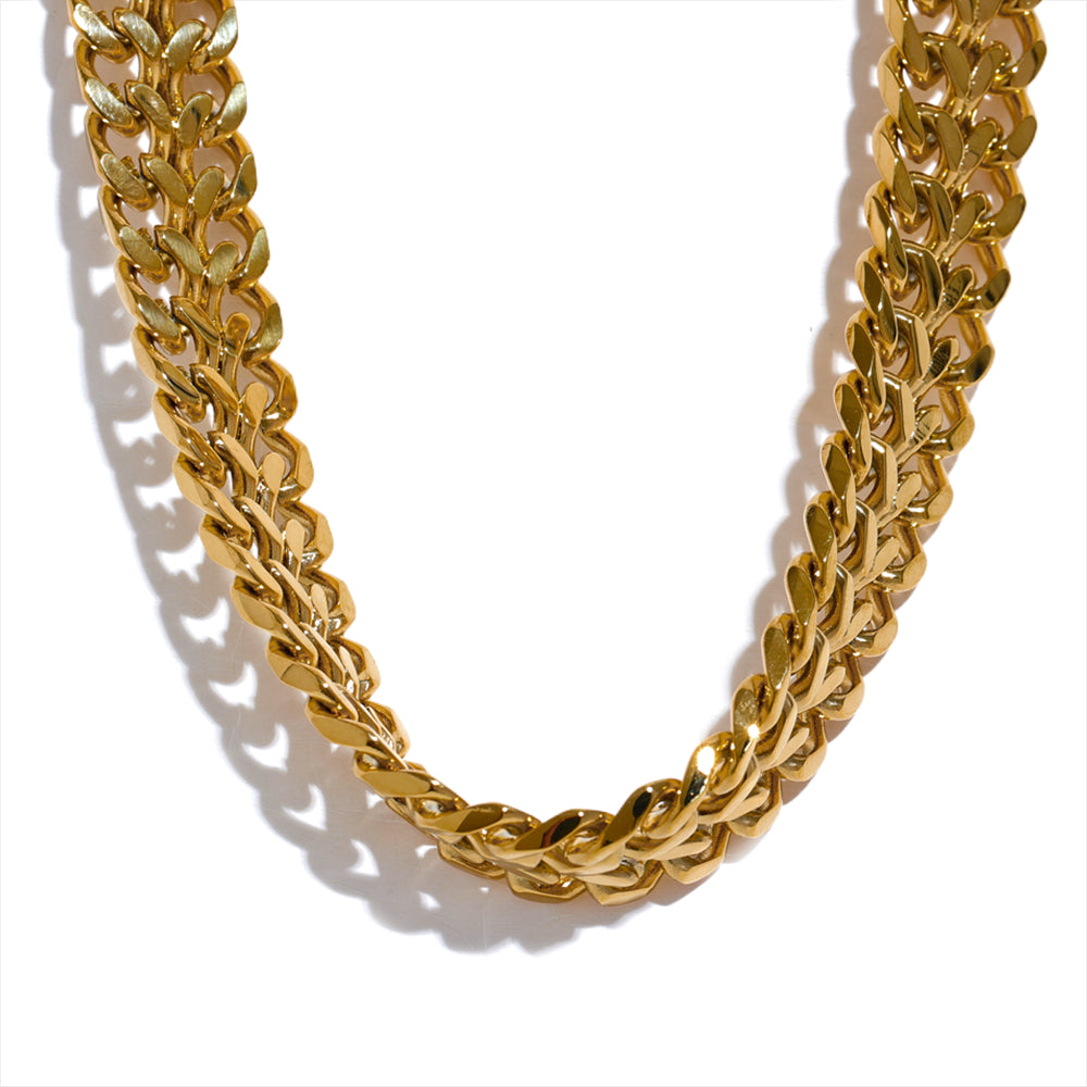 Gold chain necklace on a white background
