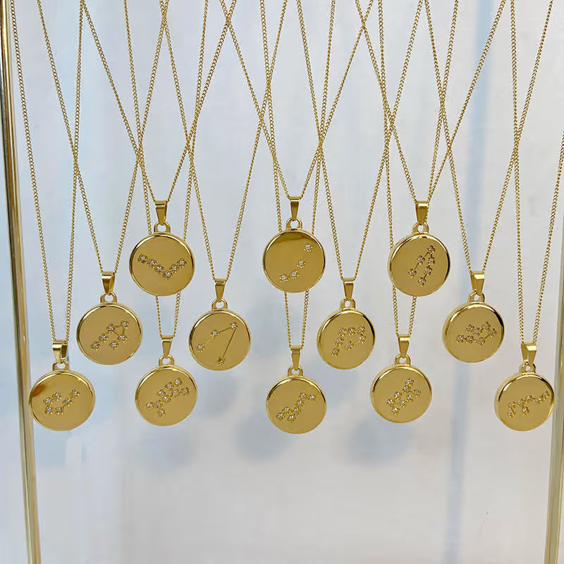 Gold necklaces with circular pendants on a white background