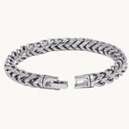 Silver chain bracelet with a clasp on a white background