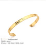 Gold bracelet on a white background with product details.