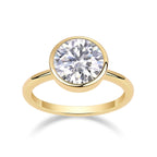 Gold ring with a large diamond on a white background