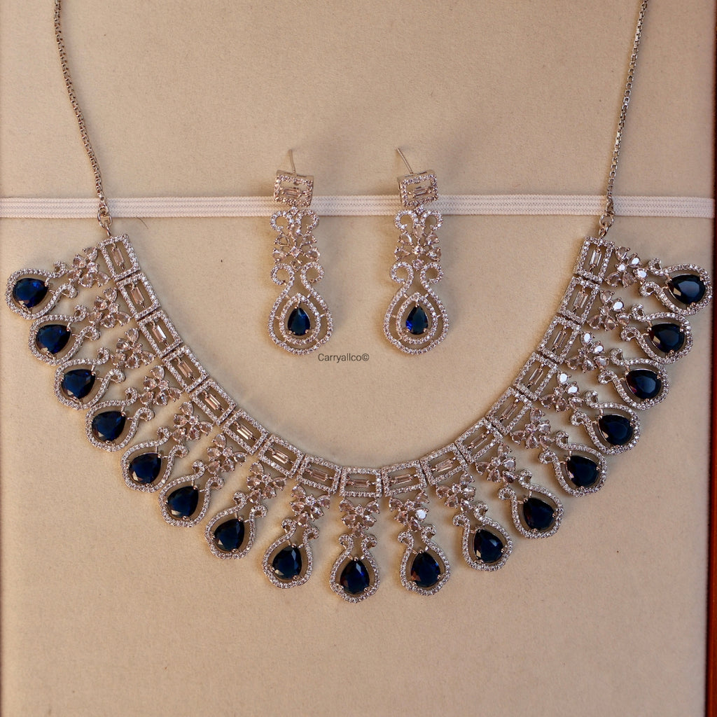 Jewelry set with necklace and earrings on a beige background