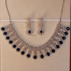 Jewelry set with necklace and earrings on a beige background