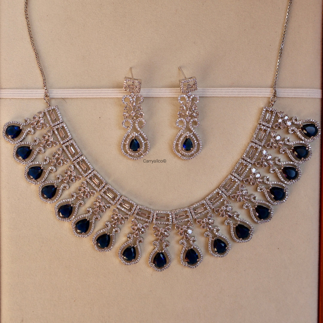 Jewelry set with necklace and earrings on a beige background